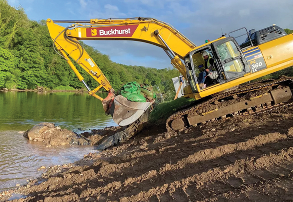 A Buckhurst digger on site being used to move construction materials