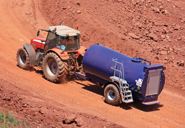 A fuel proof tank being transported by tractor